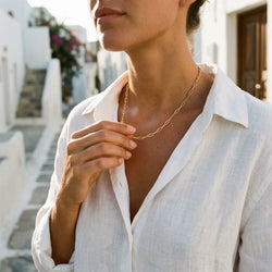 Serena Bold chain necklace in gold-plated stainless steel worn over a white linen shirt